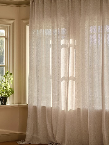 Sheer curtains glowing in a warm room