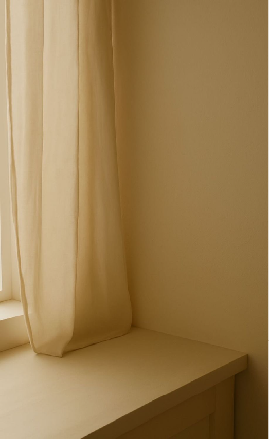 Made-to-order curtain by a sunlit window