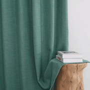 Helen dusty teal linen-look curtains with soft flowing folds beside a wooden stool