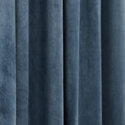 Close-up of slate blue velvet curtain fabric showing its soft texture and vertical folds