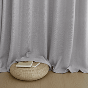 Close-up of dusty mauve room darkening curtains with soft folds resting on the floor