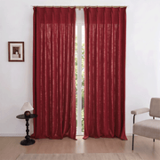 Helen burgundy linen-look room darkening curtains framing a tall window in a cozy living room