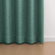 Helen Dusty Teal room darkening curtains hanging in natural folds above a wooden floor