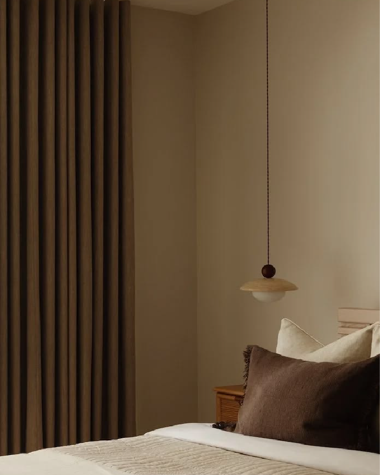 Dark curtains in a softly lit bedroom