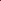 Close-up of burgundy velvet curtain with black embroidered trim and decorative pom-pom tassels