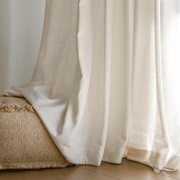 Close-up of Helen warm ivory curtains showing soft flowing folds and fabric pooling on the floor