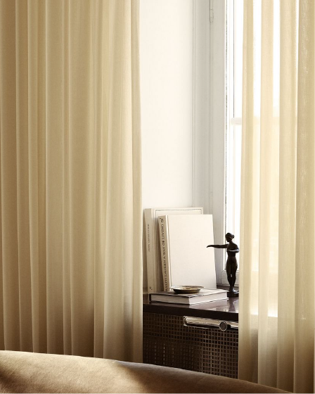 Linen-look curtains framing a quiet bedside scene