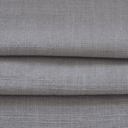 Close-up of dusty mauve linen-look curtain fabric showing its woven texture