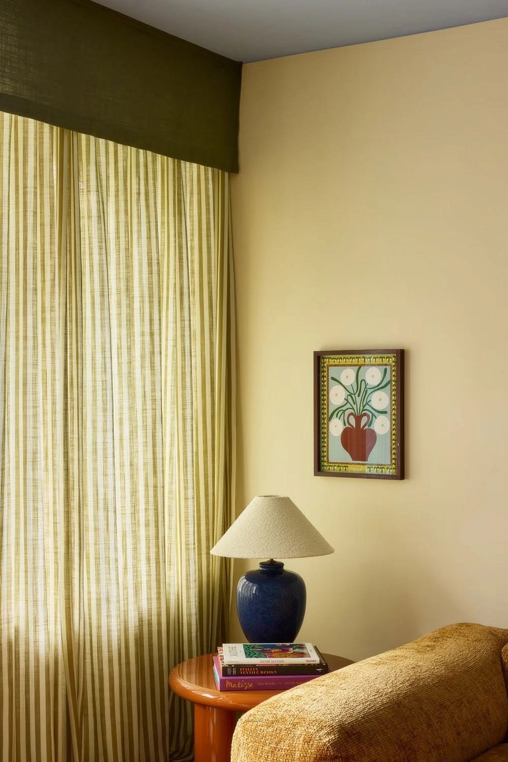 Sheer curtains in a warm yellow room